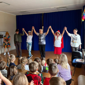 Seniorzy w przebraniach występują w przedstawieniu dla grupy dzieci